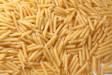 Penne pasta as background. Concept - healthy food.