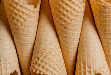 Close-up of waffle cones. Top view of the sugary texture of waffle cones. Blanks for dessert and...