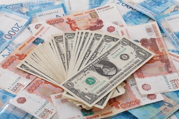 One US Dollar on Russian ruble. Money background. Currency exhange. Economic crisis. Rouble dollar cash. Hundred dollar bill and 5000 rubles. Business and finance. Russia and USA