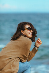 Fototapeta na wymiar woman at sea beach enjoying power of nature. windy weather