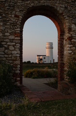 The Lighthouse In Old Hunstanton At Sunset Through Te Archway Of Abbey Ruins