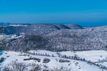 Fototapeta na wymiar Germany, Breitenstein aerial panorama view on swabian alb mountains in winter wonderland season, covered with snow, a beautiful scene