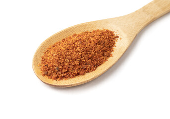 Closeup of cayenne pepper on a spoon isolated over white background