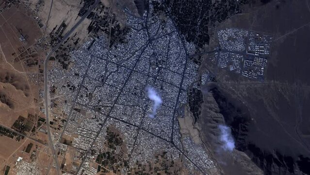 Sunrise time lapse flying over city map, urban architecture in desert,  aerial satellite view from sky. Contains image furnished by Nasa