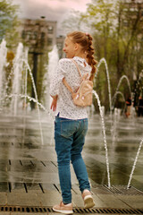 Naklejka premium Girl walking in a dry fountain