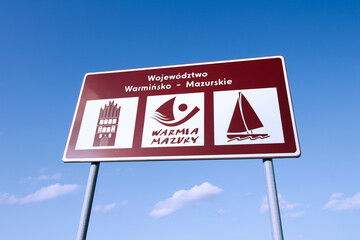 A road sign marking the Warmian-Masurian voivodeship or Warmia and Masuria region in northeastern Poland