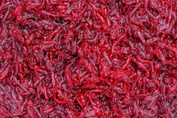 Background and texture of raw fresh grated red beetroot vegetable