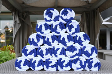 The rolled terry  of towel white with blue stripes They are beautifully stacked in a triangular...
