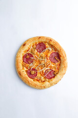 Homemade pizza with cheese and sausages. On a white background.