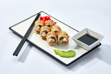California or Philadelphia sushi rolls set served on a white tray over white background. Japanese cuisine concept, traditional recipe.