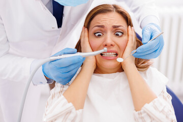 Afraid woman at dentist office - Powered by Adobe