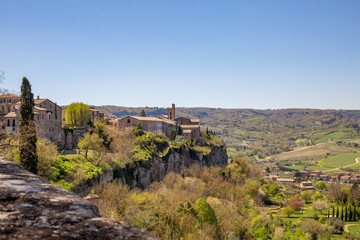 Fototapeta na wymiar View of part of the cityscape from the historic center of Orvieto. Beautiful old street of the famous medieval village on a hill of tuff rocks. Orvieto, Umbria, Italy, Province of Terni, Europe