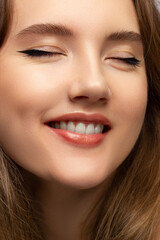 Obraz premium Close-up of woman's lips with fashion natural beige lipstick makeup. Macro sexy pale lipgloss make-up . Gentle pure skin and wavy blonde hair. Cosmetology, Spa, increase in lips