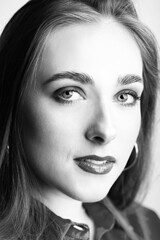 Fototapeta premium Beauty, fashion and make-up concept. Black and white close-up portrait of beautiful woman looking to camera. Profile model view