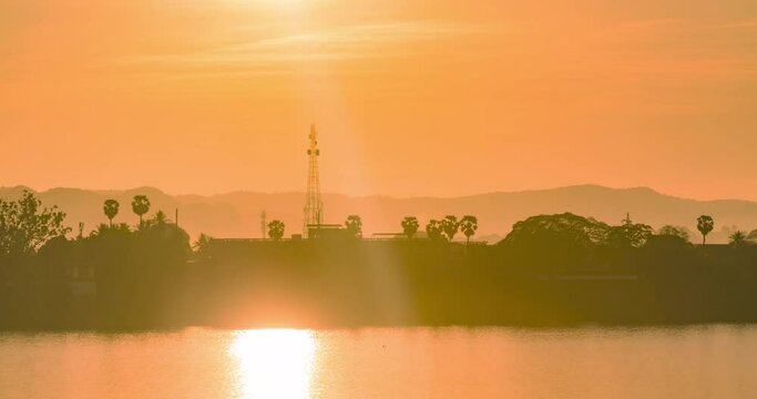 Time lapse sunrise Sunrise over the land of Laos beside the Mekong River, view from Nakhon Phanom province Thailand.