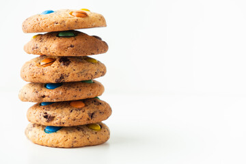 Shortbread cookies with multi-colored chocolate droplets on the white background
