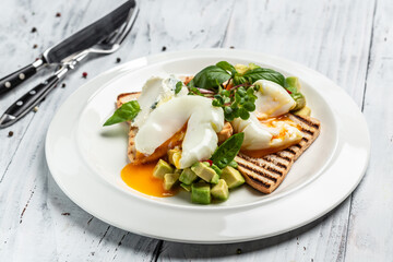 Avocado, bread toast with poached egg on plate. Healthy fats, clean eating for weight loss. Healthy appetizer, breakfast, lunch or snack