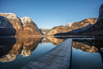 wooden pier on beautiful lake between mountains 