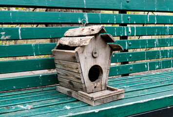 bird house in the forest on the bench