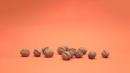 Ripe walnuts isolated on apricot background. Food concept.