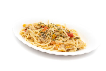 Spaghetti carbonara on a long white plate, isolated on white background. Carbonara is an Italian pasta dish originating from Lazio, and more specifically from Rome.