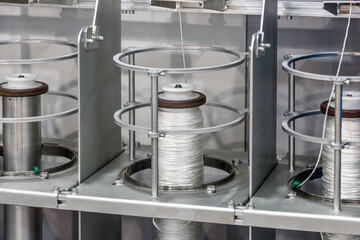 bobbins with rope on the machine of a clothing factory