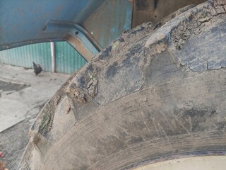 Dirty tractor wheel after work in the field, close up