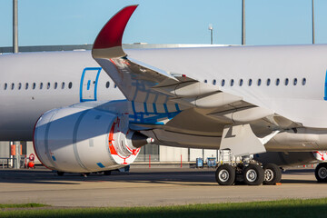 Wing and engine of modern passenger aircraft close-up. The plane is in storage due the crisis in the aviation industry.