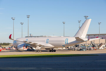 White passenger wide-body plane mothballed for storage. Side view of aircraft. Close-up.