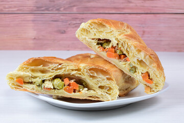 Fototapeta premium Puff pastry cake with vegetables and cheese, on wooden background