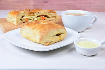 Puff pastry cake with vegetables and cheese, on wooden background