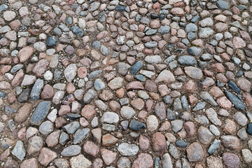 Cobbled road pavement with round granite stones