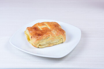 Puff pastry cheese and pineapple cake on wooden background