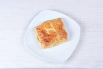 Puff pastry cheese and pineapple cake on wooden background