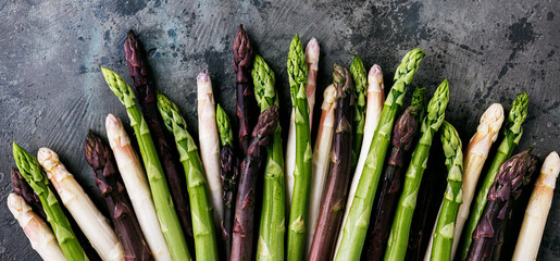 Green, white and purple asparagus on a kitchen background - 500456898
