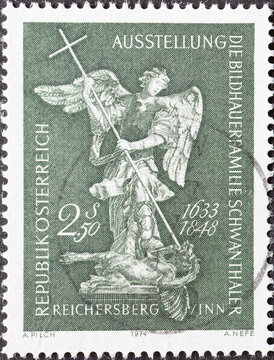 Austria - circa 1974: a postage stamp from Austria, showing an angel fighting a dragon. Exhibition "The sculptors family Schwanthaler", Reichersberg