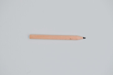 Single isolated small wooden drawing pencil, for student and children on white background