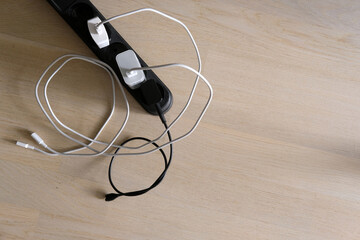 mobile usb chargers with tangled wires on floor