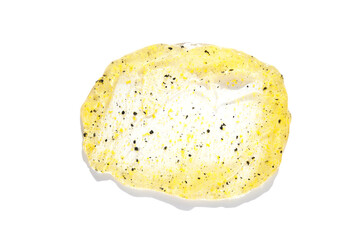 Face scrub texture. Cream skincare cosmetic. Organic stroke. Feet oily cleanser smudge. Particles in gel. White background. Top view. Yellow and black fluid treatment