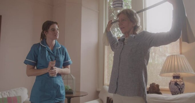 Healthcare Worker Assisting Senior woman with Exercise in Home Living room