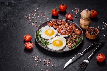 Fototapeta na wymiar Full english breakfast with bean, fried eggs, roasted sausages, tomatoes and mushrooms
