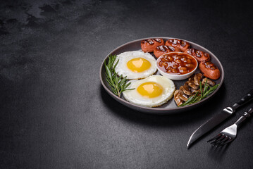 Full english breakfast with bean, fried eggs, roasted sausages, tomatoes and mushrooms