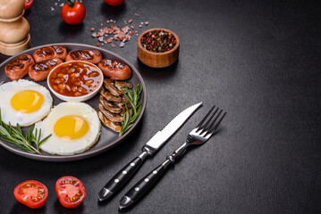 Naklejka na ściany i meble Full english breakfast with bean, fried eggs, roasted sausages, tomatoes and mushrooms