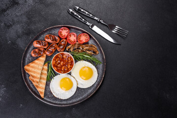 Full english breakfast with bean, fried eggs, roasted sausages, tomatoes and mushrooms
