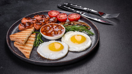 Full english breakfast with bean, fried eggs, roasted sausages, tomatoes and mushrooms