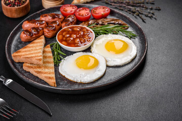 Full english breakfast with bean, fried eggs, roasted sausages, tomatoes and mushrooms