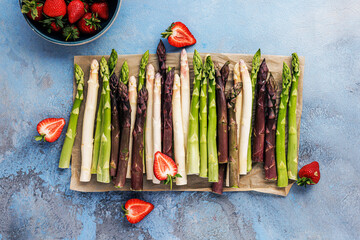 Green, white and purple asparagus on a kitchen background - 500461042