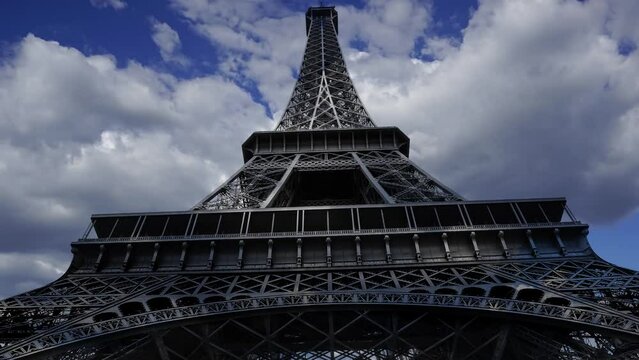 Eiffel Tower in Paris, France (against the background of moving clouds, time lapse, with zoom) 