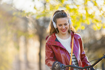 Fototapeta na wymiar smiling woman listening to music outside on city street