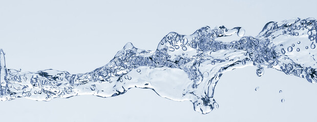 Splash of water from a bottle on a white background. Reflection on the surface of the water.